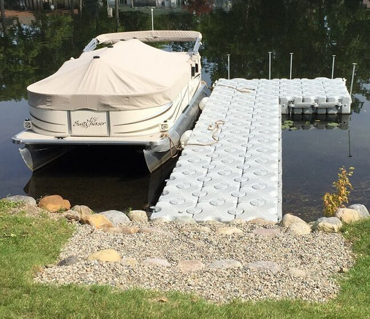 Floating courtesy dock next to a boat