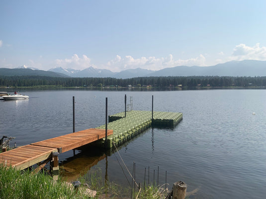 Green floating swimming dock on a lake