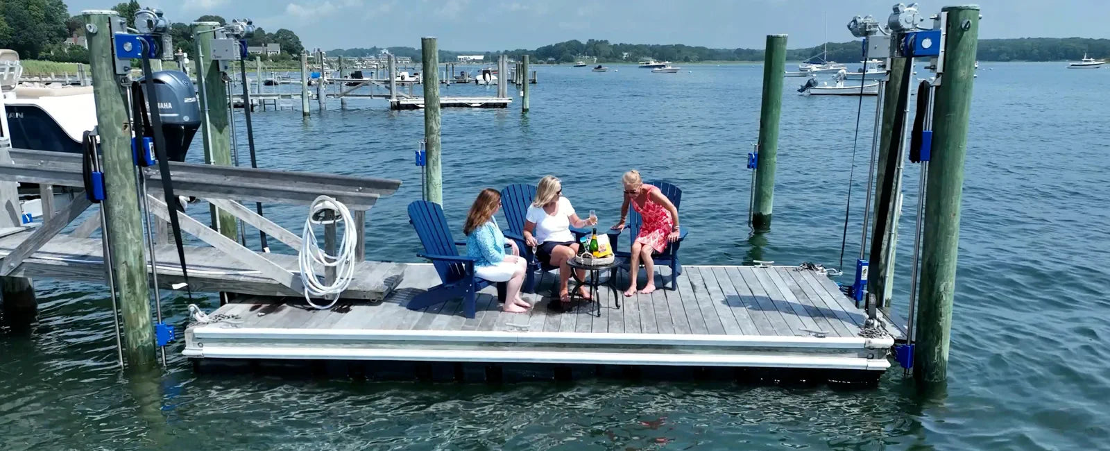 Dock lowered to water level with guests seated on the deck