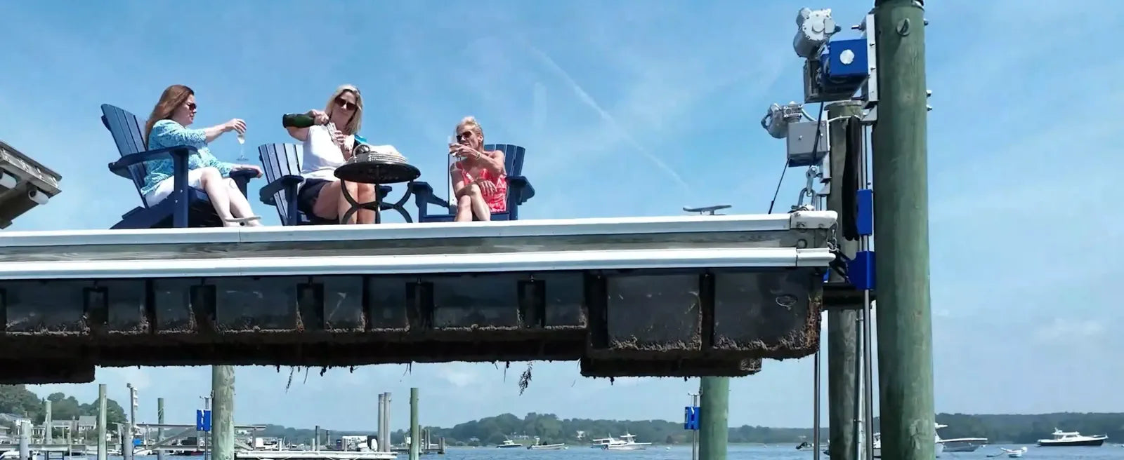 Dock raised to deck height with guests seated on top